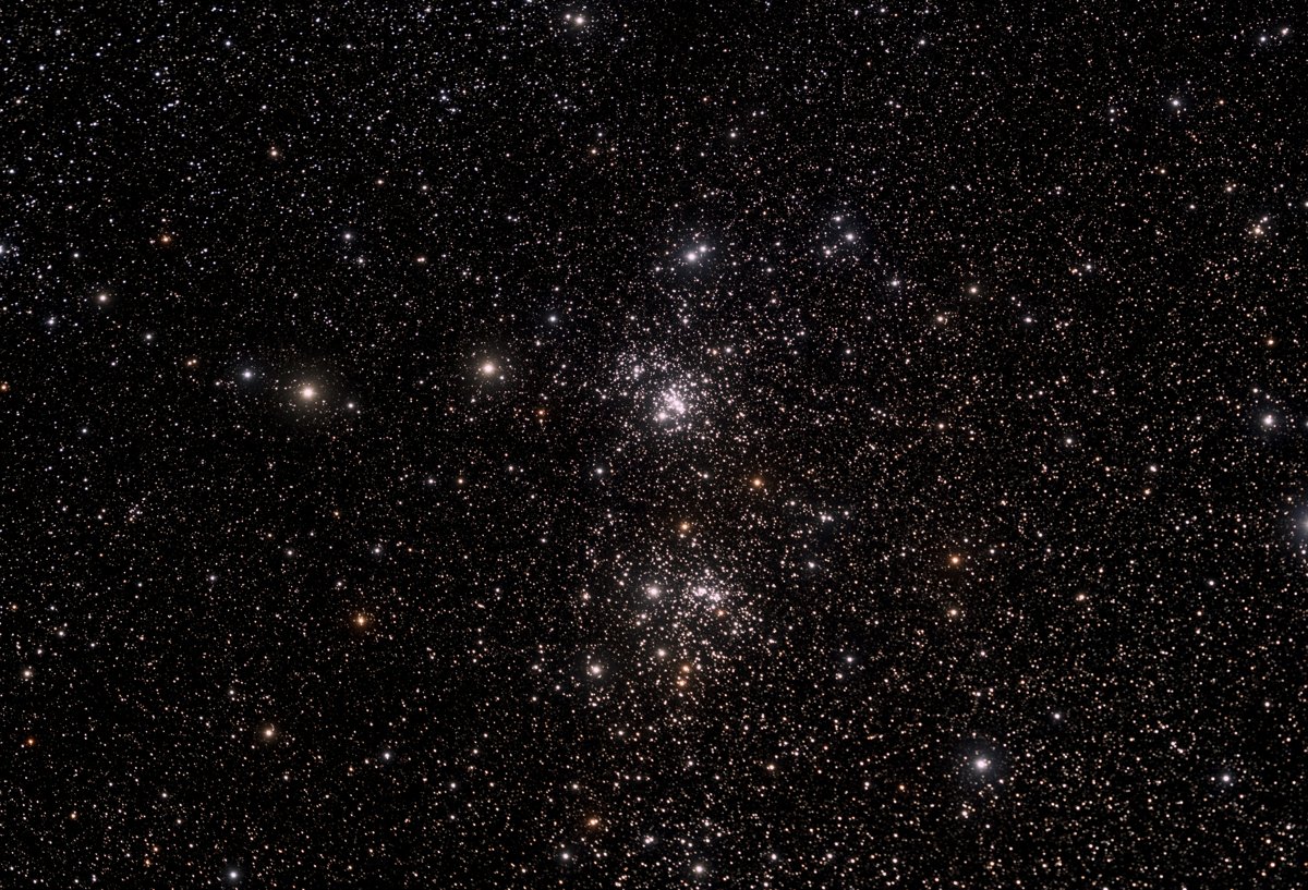 Processed photograph of the Double Cluster; not an eyepiece view.