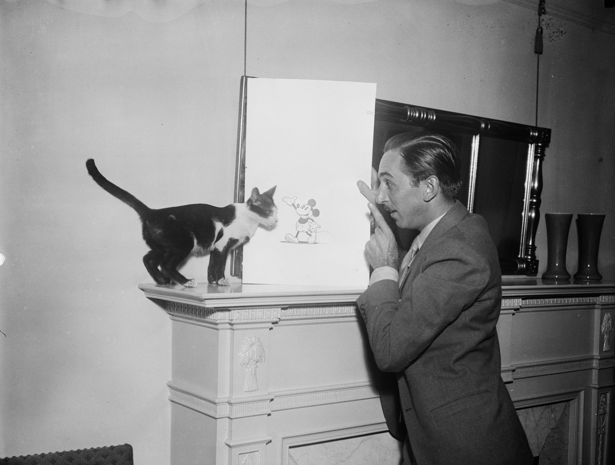 Walt Disney with a Mickey Mouse drawing, 1931.